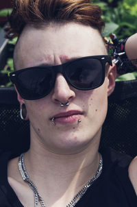 Close-up of woman wearing sunglasses while sitting on chair