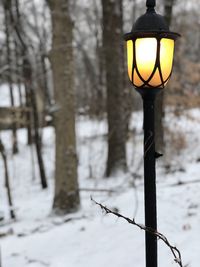 Street light on snow covered field