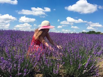 Woman working on field against sky