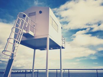 Low angle view of lookout tower against clouds