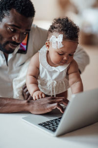 Father and son using smart phone