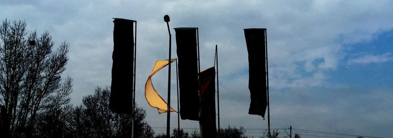 Low angle view of street light against cloudy sky