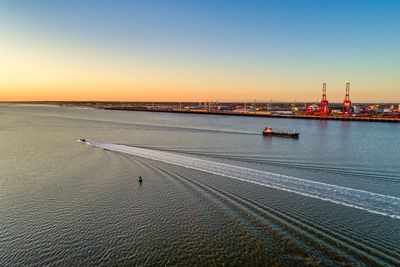 Scenic view of sea against clear sky during sunset