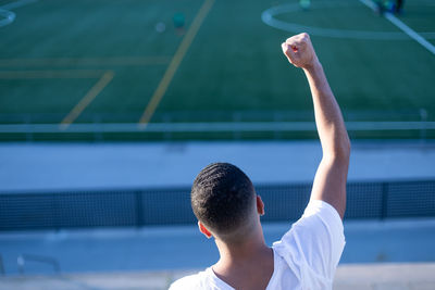 Rear view of man playing tennis