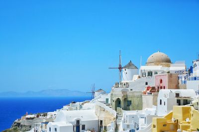 High angle view of buildings by sea against sky