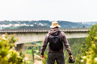 Rear view of man standing against sky