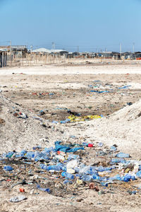 Garbage on beach against clear sky