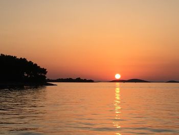 Scenic view of sea against romantic sky at sunset