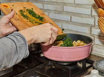 Cropped hand of person holding food