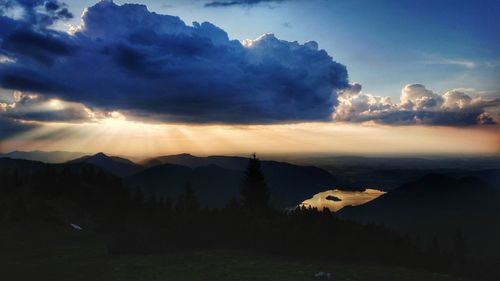 Scenic view of silhouette mountains against sky at sunset