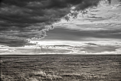 Scenic view of landscape against cloudy sky