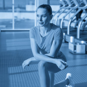 Portrait of young woman exercising in gym