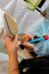 Midsection of bride writing on sandal