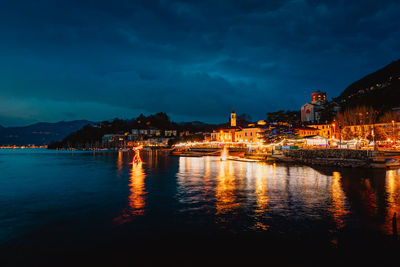 View of laveno with christmas lighting on lake maggiore at night