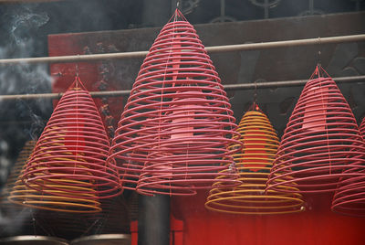 Close-up of red bell hanging outside temple