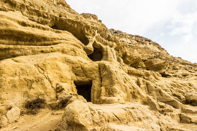 Low angle view of rock formation against sky