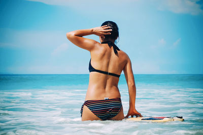 Full length of woman on beach against sky