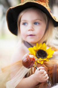 Smiling girl wearing witch hat