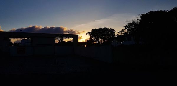 Silhouette trees against sky during sunset