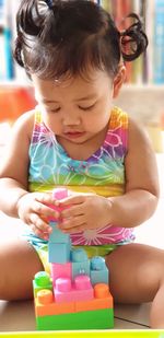 Cute baby girl playing with toy blocks