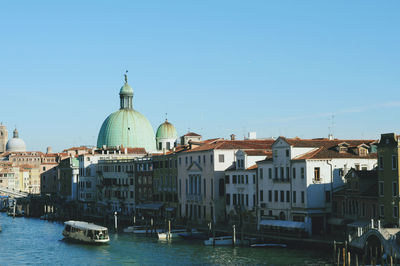 View of buildings in city against clear sky
