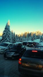 Cars on road against sky during winter