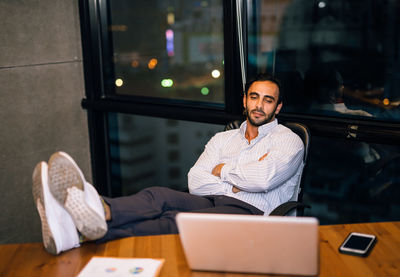 Businessman using laptop at desk in office