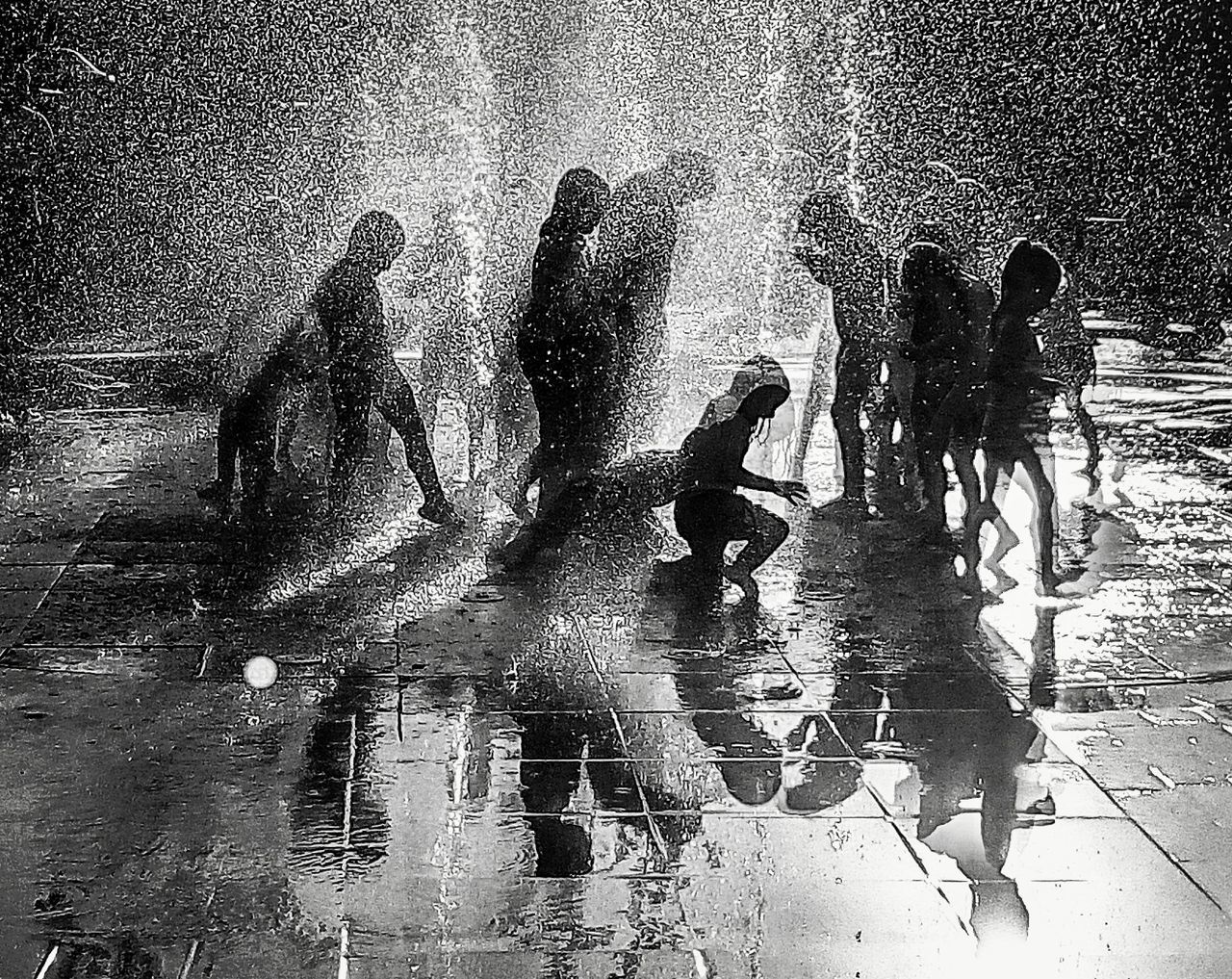 group of people, water, black and white, wet, lifestyles, men, monochrome, monochrome photography, women, nature, day, leisure activity, city, child, street, outdoors, adult, childhood, black, silhouette, architecture, rain, high angle view, small group of people