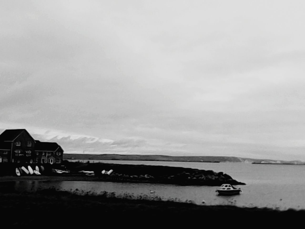 water, sea, sky, tranquil scene, tranquility, nautical vessel, beach, scenics, transportation, cloud - sky, beauty in nature, boat, mode of transport, shore, nature, horizon over water, mountain, moored, cloudy, cloud