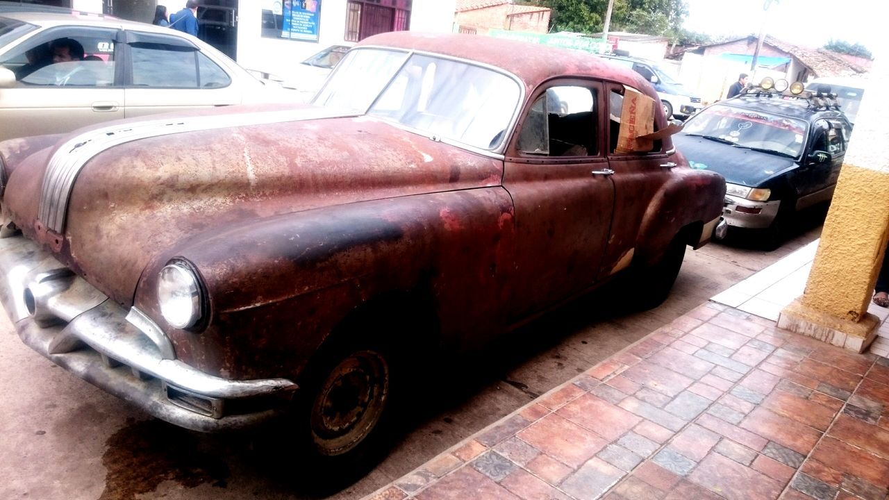 transportation, mode of transport, land vehicle, stationary, old, parked, obsolete, wheel, parking, rusty, run-down, damaged, deterioration, tire, vintage car, day, outdoors, no people, part of, machinery, pipe - tube