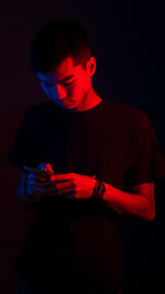 Full length of man standing against black background