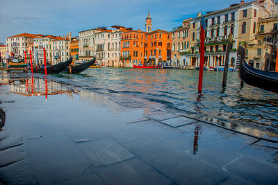 High water invading the pedestrian sidewalk in the grand canal of venice