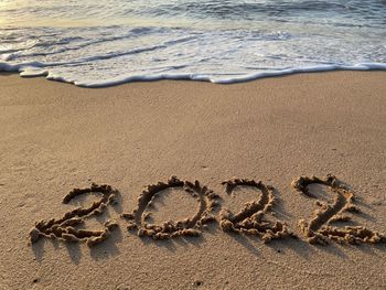 High angle view of text on beach