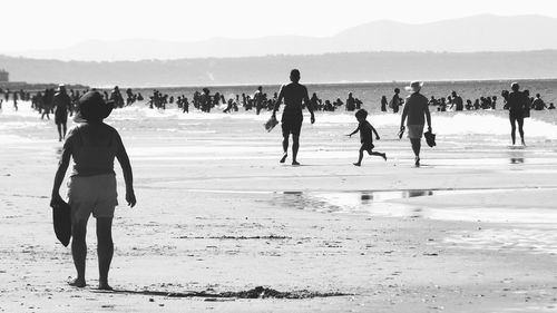 People on beach against sky