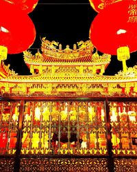 Illuminated lanterns in temple at night