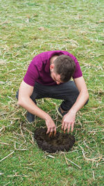 High angle view of man relaxing on field