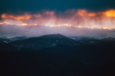 Scenic view of mountains against sky at sunset