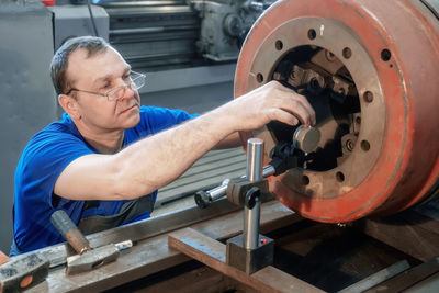 Side view of man working at workshop