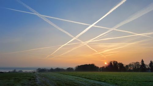 Scenic view of field against sky during sunset