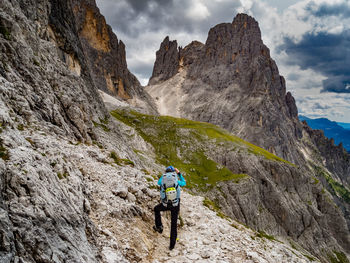 Rear view of man climbing on mountain