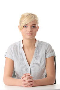 Portrait of a smiling young woman against white background