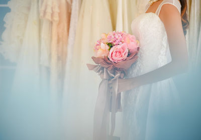 Midsection of woman holding flower bouquet