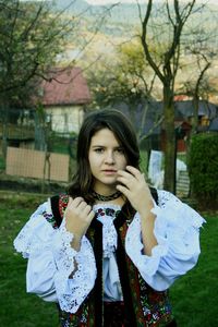 Portrait of beautiful young woman standing outdoors