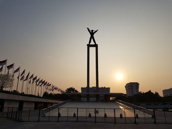 Silhouette of building against sky during sunset