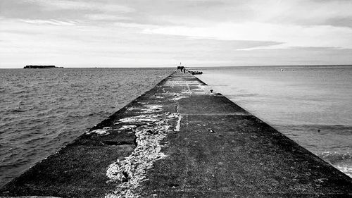 Scenic view of sea against cloudy sky