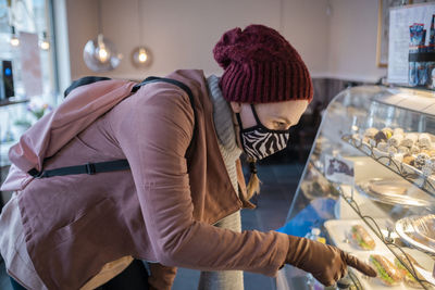 Woman with face mask in café