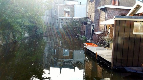 High angle view of canal amidst buildings in city