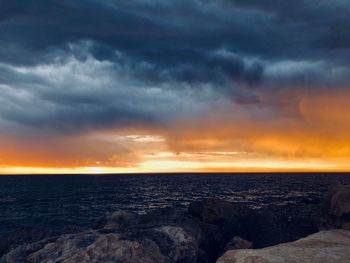 Scenic view of sea against dramatic sky