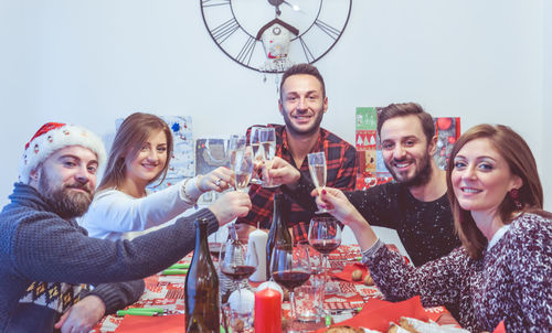 Friends toasting champagne flute at home