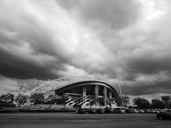 Suspension bridge against cloudy sky